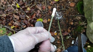 Autumn outdoor self catheter insertion, pee in forest