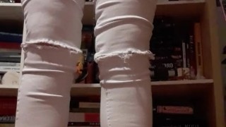 Girl pissing in white jeans onto a carpet 