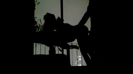 Silhouettes in the balcony at night