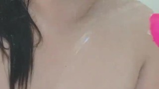 Chubby busty girl teases in the shower with vibrator