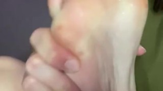 Spits on feet. Saliva drops on soles.