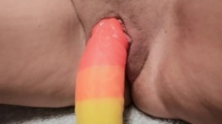 Sliding a thick dildo out 
