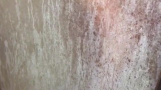 Watching her shower, she briefly presses her tits & ass on the glass door to tease me with her body 