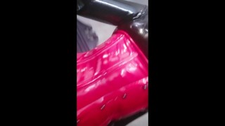 Black latex rubber catsuit and red fetish corset with thigh high boots, selfie video