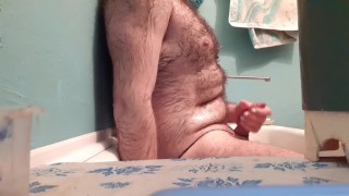 Hairy guy is satisfied in the bathroom.