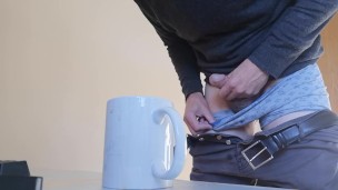 Guy jerking off and cumming into an empty cup of coffee