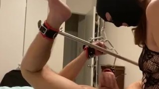 Femdom pegging sub locked in spreader bar chained to the ceiling 