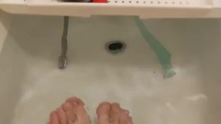 skinny twig strokes his cock and pissed in sink and shows off feet in bathtub