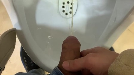 Jerk off a guy's dick in a public toilet. risky