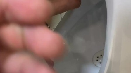 Jerk off a guy's dick in a public toilet. risky