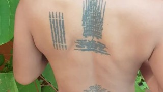 Slave May is showing her tattoos next to the swimming pool