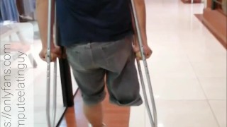 Amputee guy walking with crutches