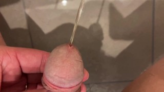 Massive urination of a muscular man