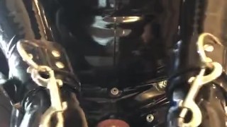 Rubber gimp in chastity shows off 