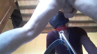 Tied to a machine, masked and hooded, she has to suck a big dick