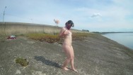 The girl undresses, walks and masturbates near the road by the lake Porn Videos