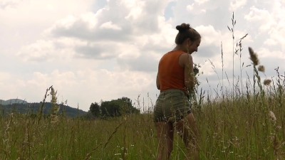 Hot girl is picking flowers in the field and spreads her legs for ...