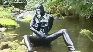 Outdoor walk in the wood and river bath full encased in black latex catsuit and rubber gas mask