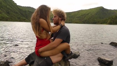 Horny couple pleasuring each other and making love passionately at a volcanic crater lake