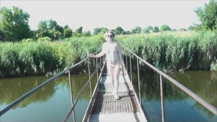 Messalina Dressed in Sun. Outside Outdoor. Nude Milf walks by bridge River. Naturist Nudist Woman