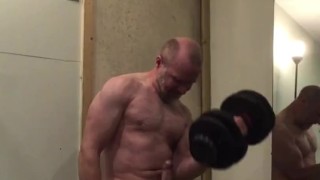 Muscle guy getting turned on pumping biceps with huge hard cock!