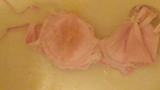 pissing on cup of pink bra!
