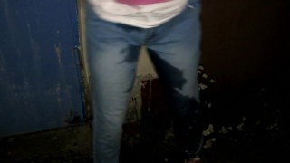 Crazy girl pissing trough her panties and jeans outside