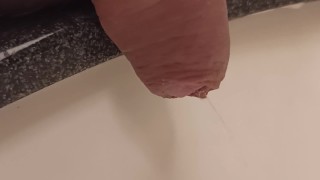 close up pee in sink. uncutted