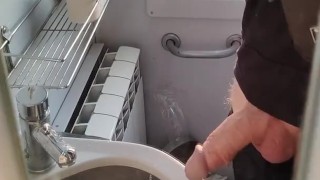 Caressing cock in the train toilet
