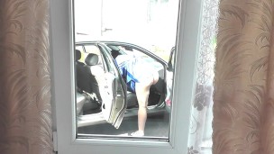 Outdoor Public. Mommy Milf no panties washes car salon in yard of house neighbor looks out window