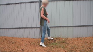 pissing with a powerful stream on the street by the fence 4K