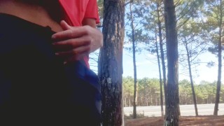 Sexy guy jacking off in public near the road.