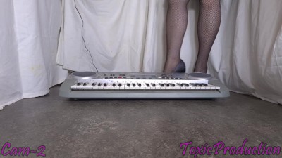 Synth keyboard crushed under her sexy heels