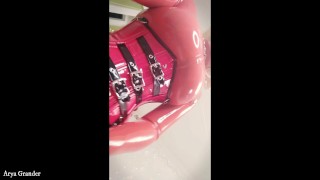 blonde MILF in red latex rubber catsuit teasing with strap-on