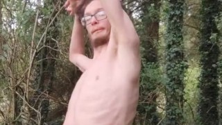 Very skinny lad strips outside in the woods in nature and shows off his body while touching himself