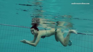 Russian girl swims nude while stripping in the pool
