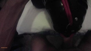 Milf hogtied in latex and high heels with a lip open mouth gag POV. Great mouth fucking action