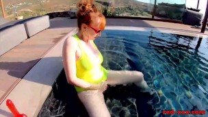 Busty redhead wife masturbates while outside in the pool