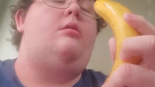 Fat male testing throat with banana