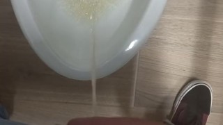 Peeing in a bathroom stall