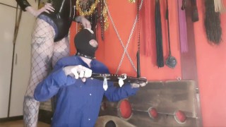 Sperm games. The dominatrix brings used condoms and pours the contents over her slave's head.