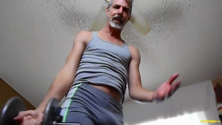 Gay DILF shows off his bulge while working out