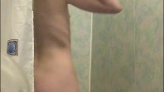 Girl pissing in the shower - Rear view and then washing her hairy pussy