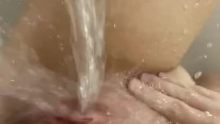 Horny babe masturbates in the bathtub and orgasms