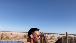 Fitness young man gets naked on Barcelona public beach after gym workout