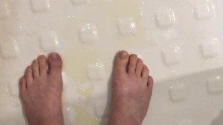 Girl pisses in her hand with cum in pussy, feet in urine