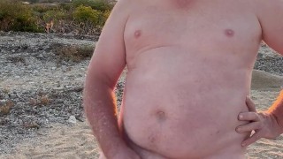Naked on the beach wanking and cuming on the rock