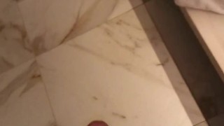 Showing cum on hand after jerking off at hotel toilet