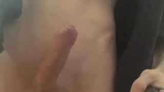 a boy jerks off his penis in a black jacket with different toys, cumming with an eruption of sperm