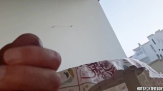 Risky Thrill: Sexy Stud Boldly Strokes His Big Cock on Public Balcony